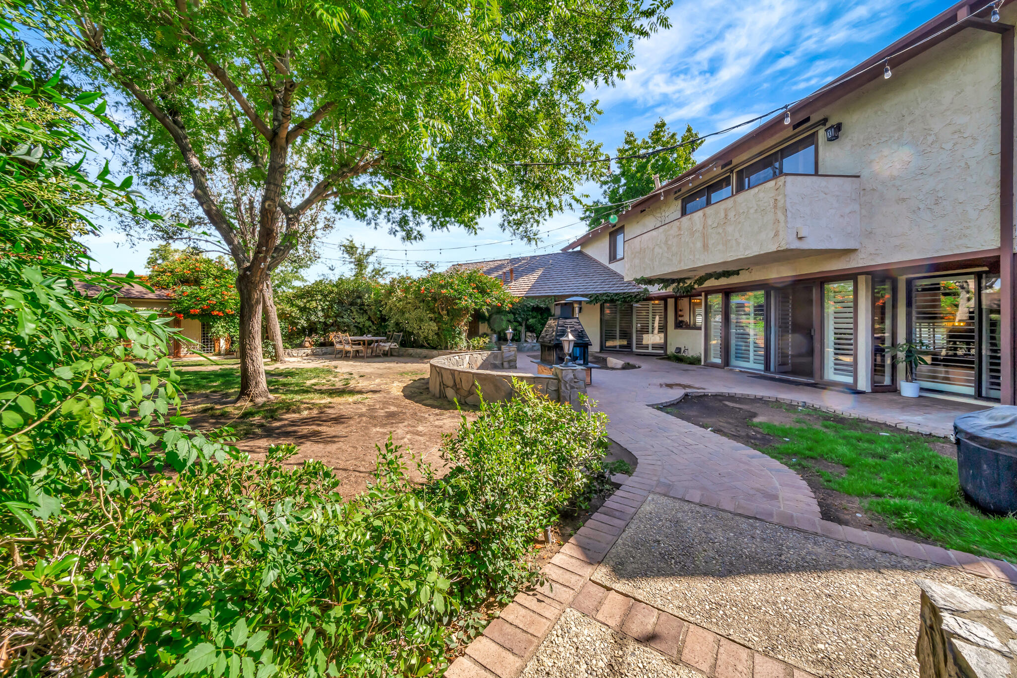 39844 Golfers Drive Palmdale, CA 93551 - Photo 60 of 87 a view of a patio with table and chairs under an umbrella