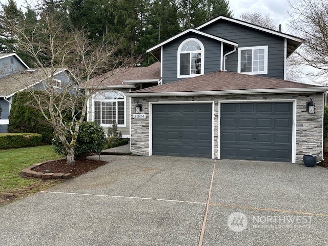 a view of a house with a yard and garage