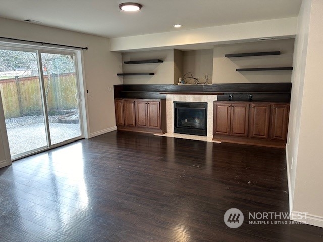 3004 200th Place Southeast Bothell, WA 98012 - Photo 11 of 24 an empty room with wooden floor a fireplace and windows
