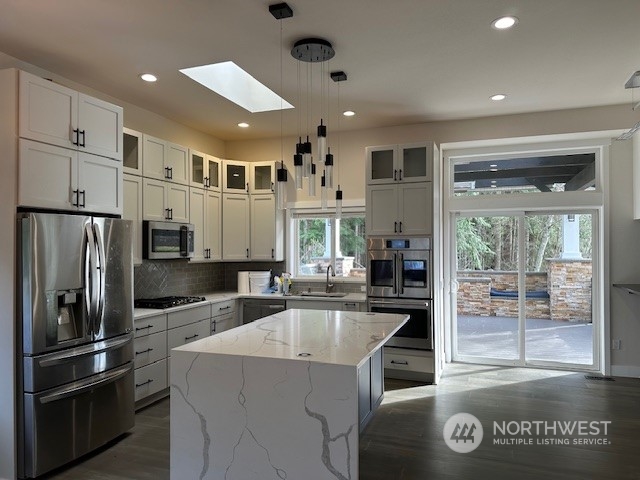 3004 200th Place Southeast Bothell, WA 98012 - Photo 8 of 24 a kitchen with kitchen island a counter top space stainless steel appliances and cabinets
