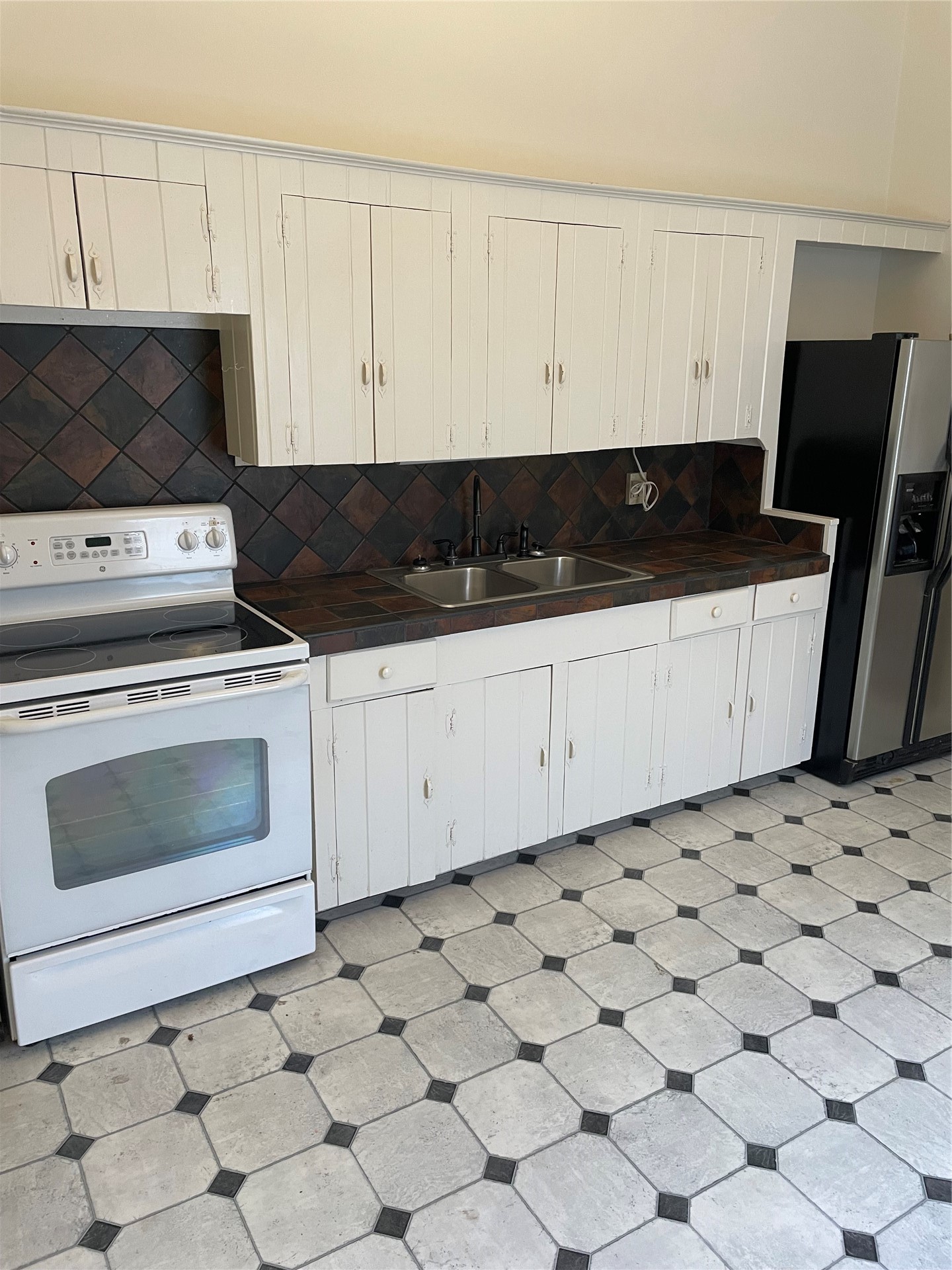 514 South 6th Street Fernandina Beach, FL 32034 - Photo 13 of 15 a kitchen with white cabinets and appliances