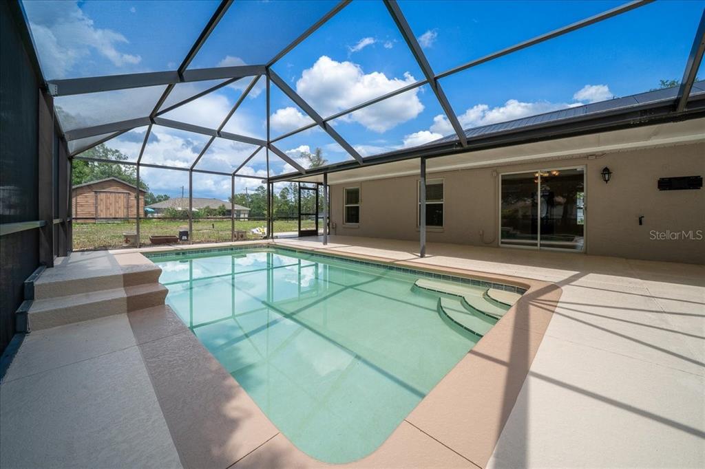 234 Locust Lane Ocala, FL 34472 - Photo 31 of 71 a view of a swimming pool with a patio