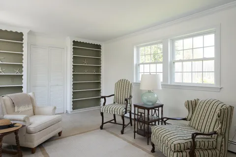 a living room with furniture a lamp and a window