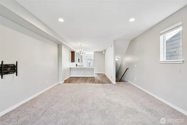 a bedroom with a bed and a flat tv screen next to a window