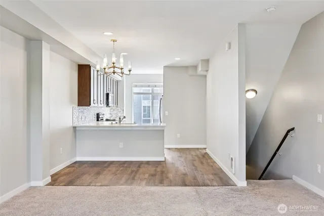 a view of an empty room with a window and closet area