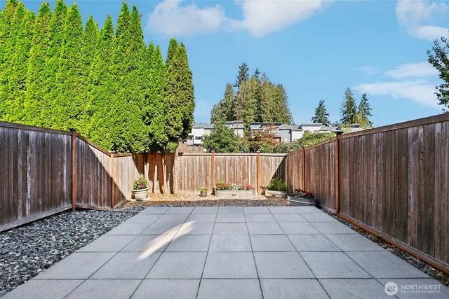 a living room with furniture a flat screen tv and a floor to ceiling window