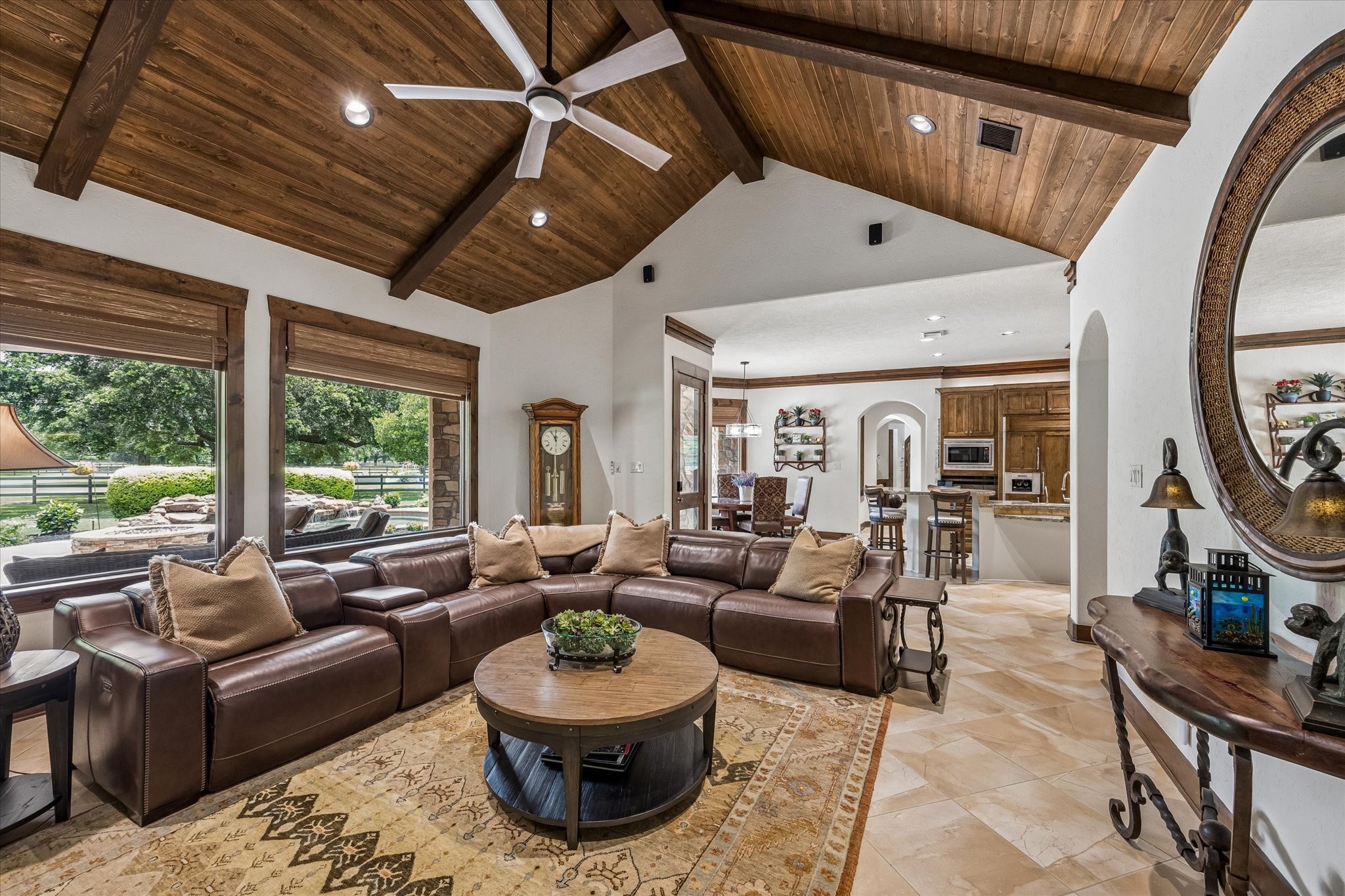 32102 Fulbrook Commons Fulshear, TX 77441 - Photo 8 of 50 Expansive windows fill the space with natural light while seamlessly connecting indoor living to the outdoor setting. The wood ceiling with beams is the showstopper in this gorgeous space.