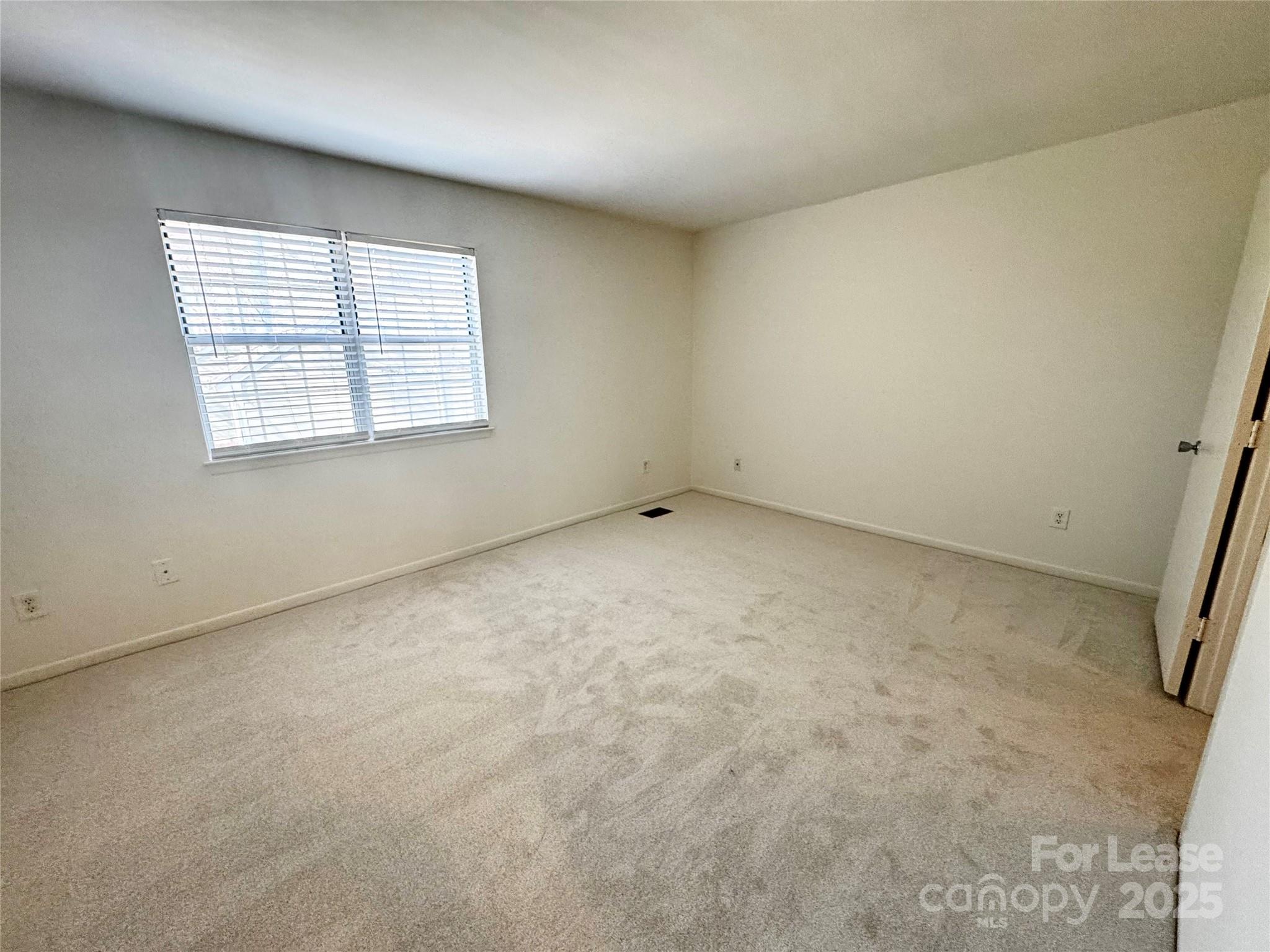 6102 Heath Ridge Court Charlotte, NC 28210 - Photo 16 of 23 an empty room with a window