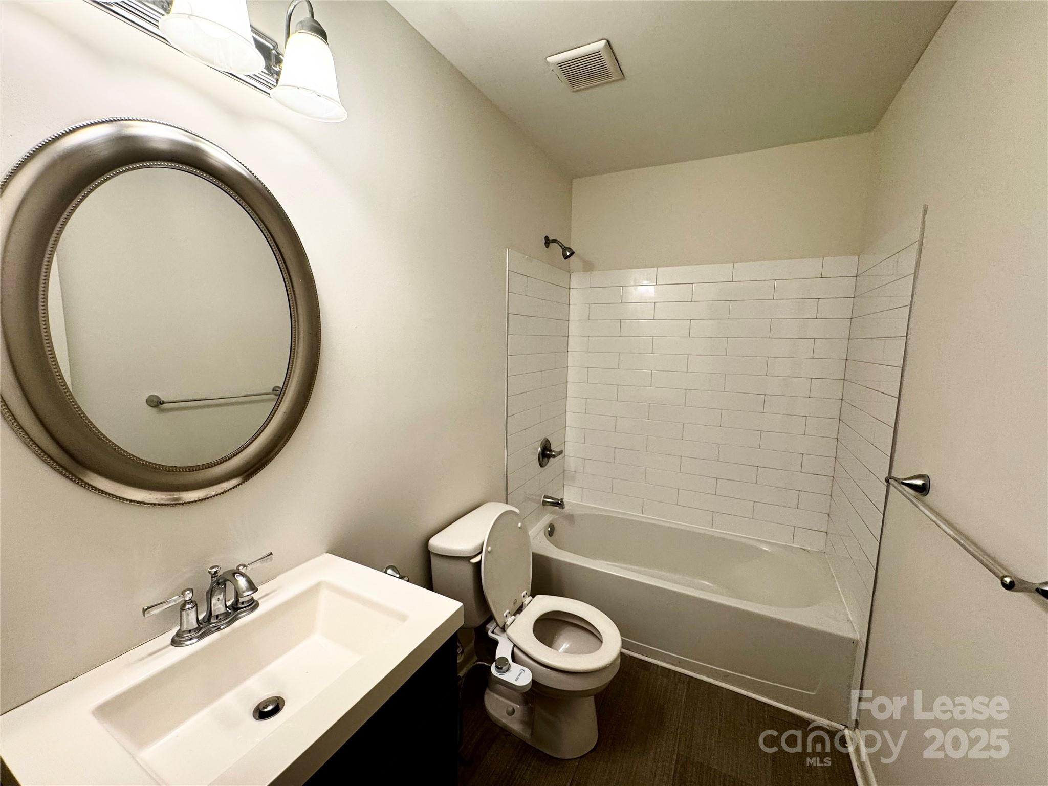 6102 Heath Ridge Court Charlotte, NC 28210 - Photo 17 of 23 a bathroom with a sink a toilet and a mirror