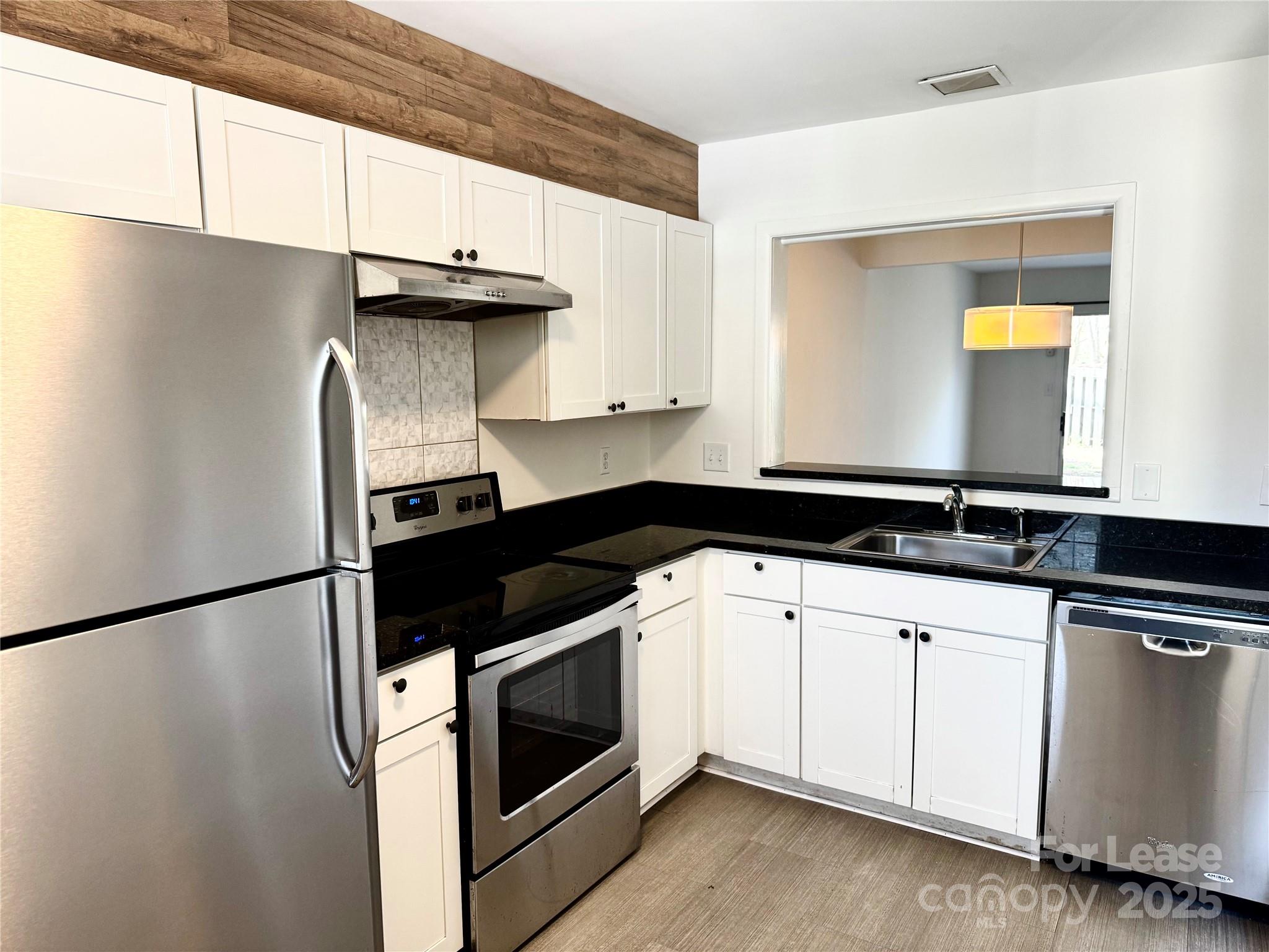 6102 Heath Ridge Court Charlotte, NC 28210 - Photo 2 of 23 a kitchen with a sink and a refrigerator