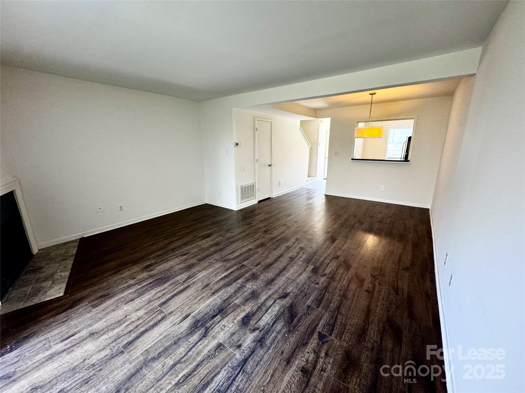 6102 Heath Ridge Court Charlotte, NC 28210 - Photo 9 of 23 a view of an empty room and wooden floor