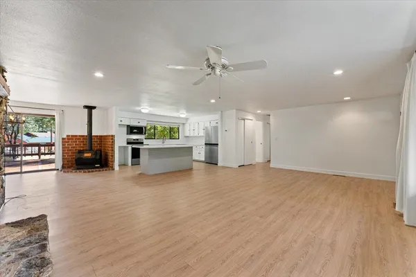 a view of a kitchen with a sink and a large window