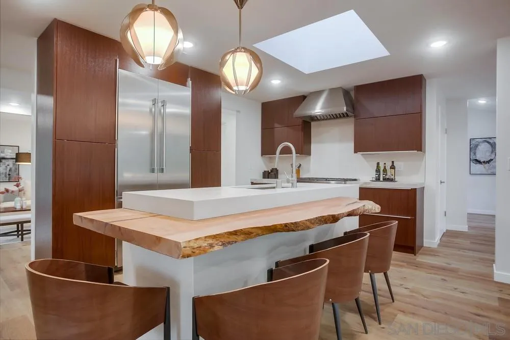 458 Avenida Adobe Escondido, CA 92029 - Photo 19 of 59 a kitchen with stainless steel appliances granite countertop a sink a stove and chairs