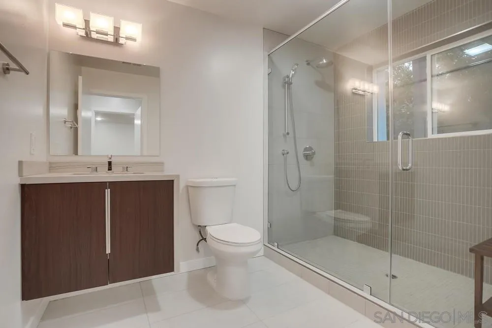 458 Avenida Adobe Escondido, CA 92029 - Photo 22 of 59 a bathroom with a shower sink vanity and toilet