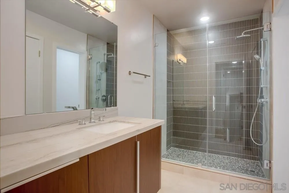 458 Avenida Adobe Escondido, CA 92029 - Photo 25 of 59 a bathroom with a shower sink and mirror