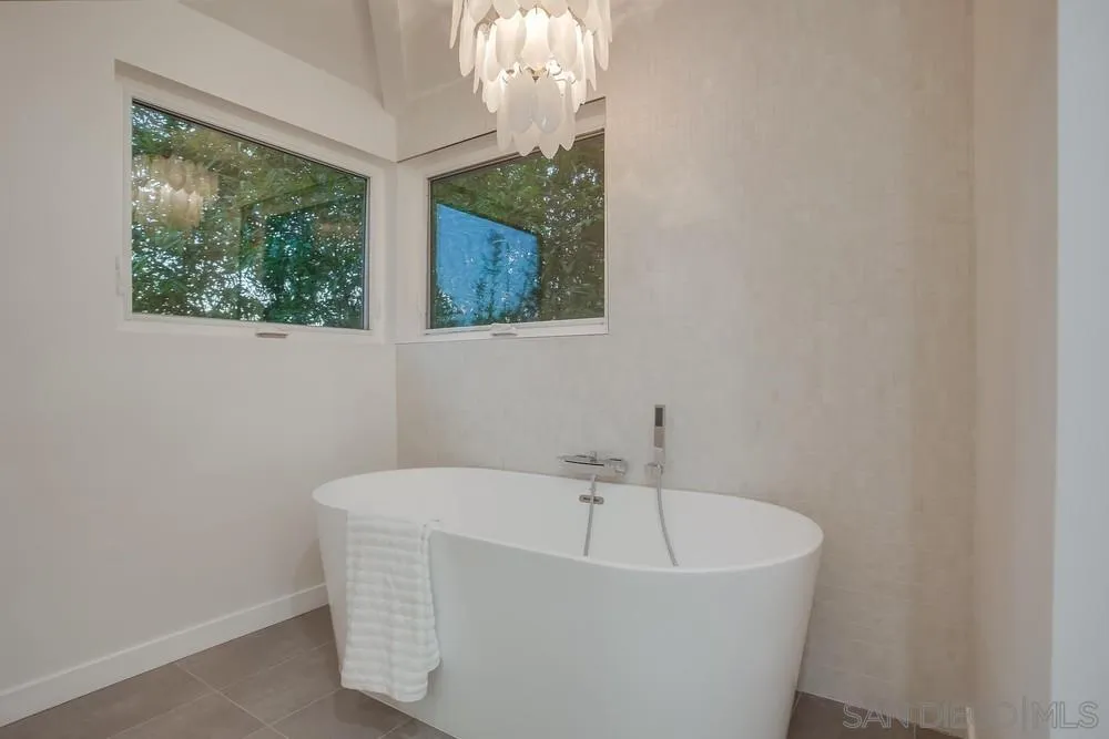 458 Avenida Adobe Escondido, CA 92029 - Photo 36 of 59 a white bath tub sitting in a bathroom next to a window