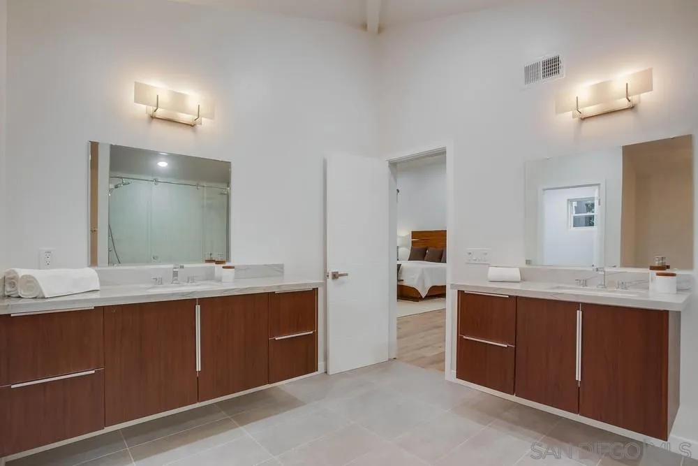 458 Avenida Adobe Escondido, CA 92029 - Photo 37 of 59 a view with a double vanity sink and mirror