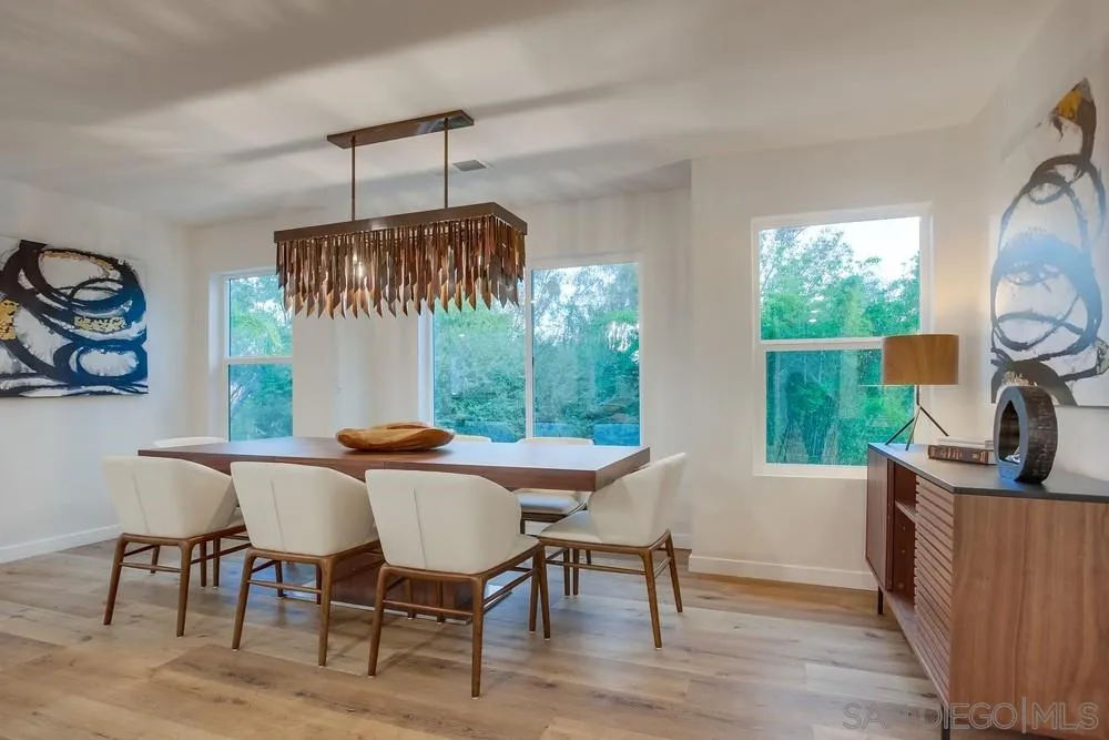 458 Avenida Adobe Escondido, CA 92029 - Photo 52 of 59 a dining room with furniture a fireplace and wooden floor