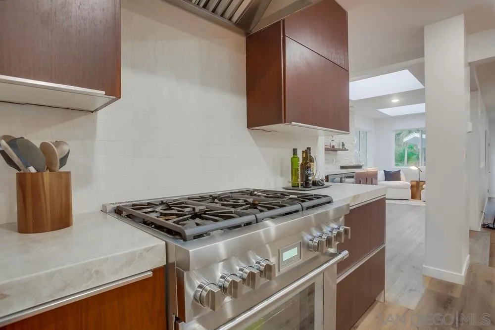 458 Avenida Adobe Escondido, CA 92029 - Photo 56 of 59 a kitchen with stainless steel appliances granite countertop a stove a sink and a microwave