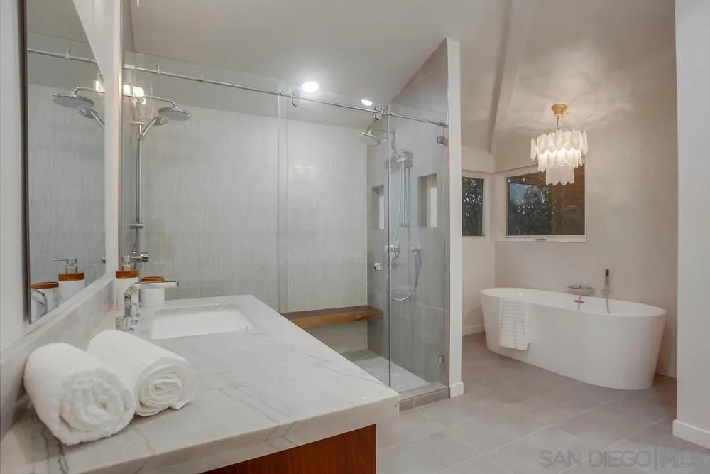 458 Avenida Adobe Escondido, CA 92029 - Photo 8 of 59 a bathroom with a granite countertop sink a toilet a mirror and shower
