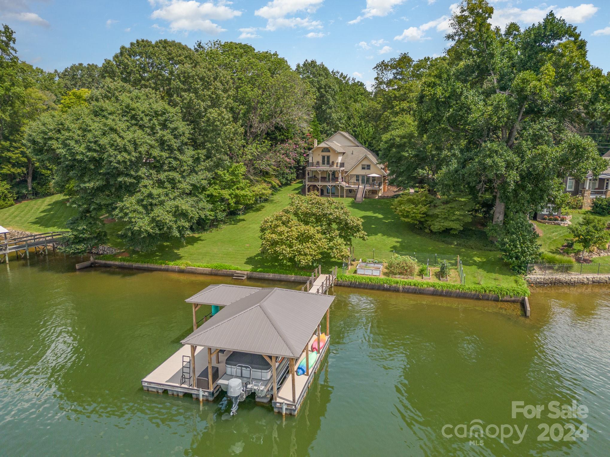 an aerial view of a house with a yard lake view and mountain view