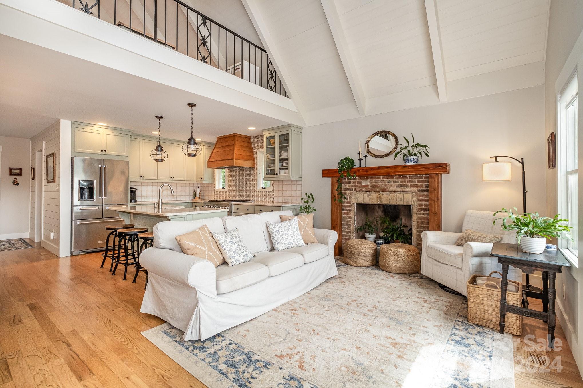 7707 Dellinger Road Denver, NC 28037 - Photo 18 of 46 a living room with furniture a fireplace and a table