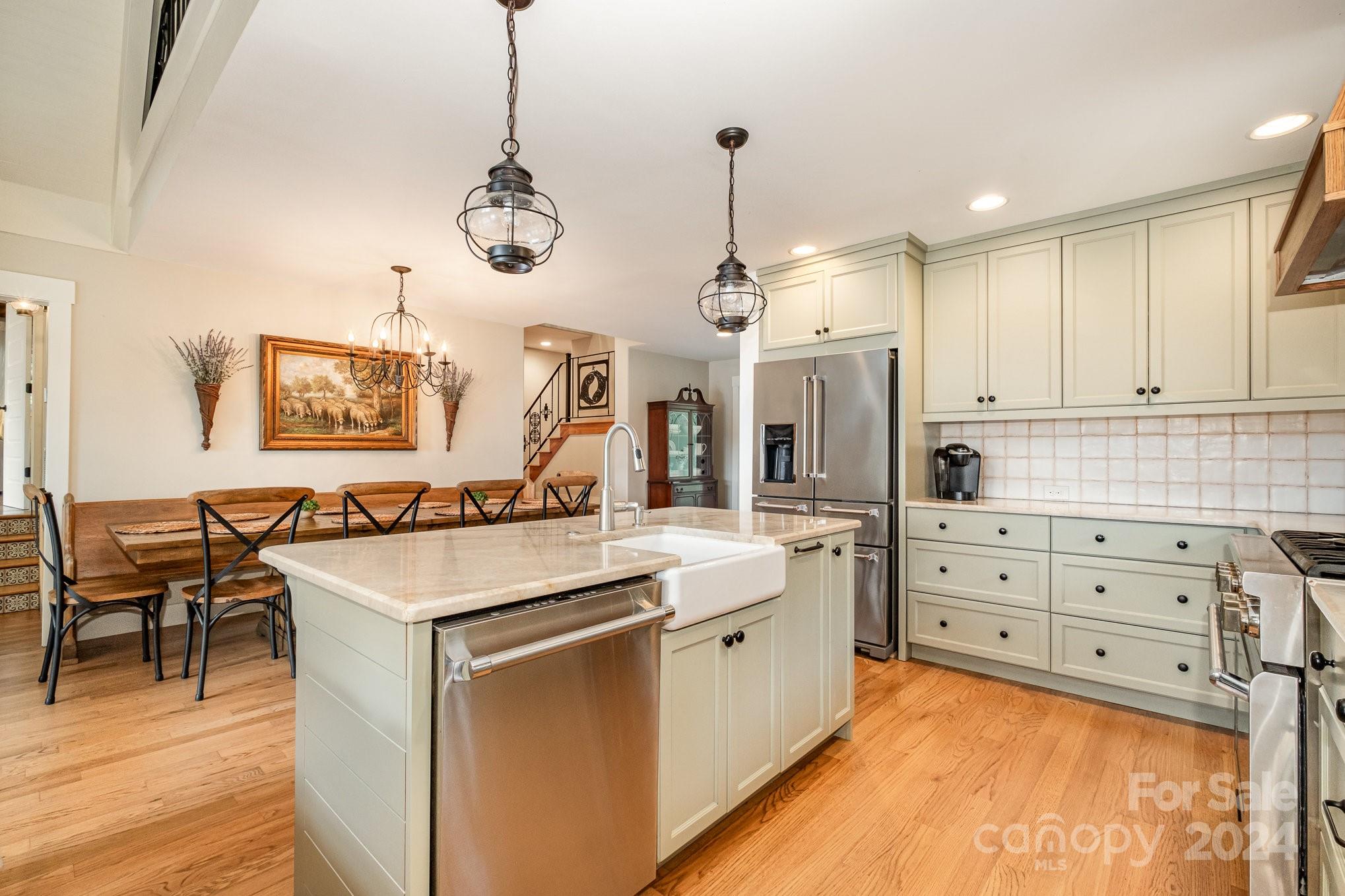 7707 Dellinger Road Denver, NC 28037 - Photo 27 of 46 a kitchen with a stove a chandelier and a refrigerator