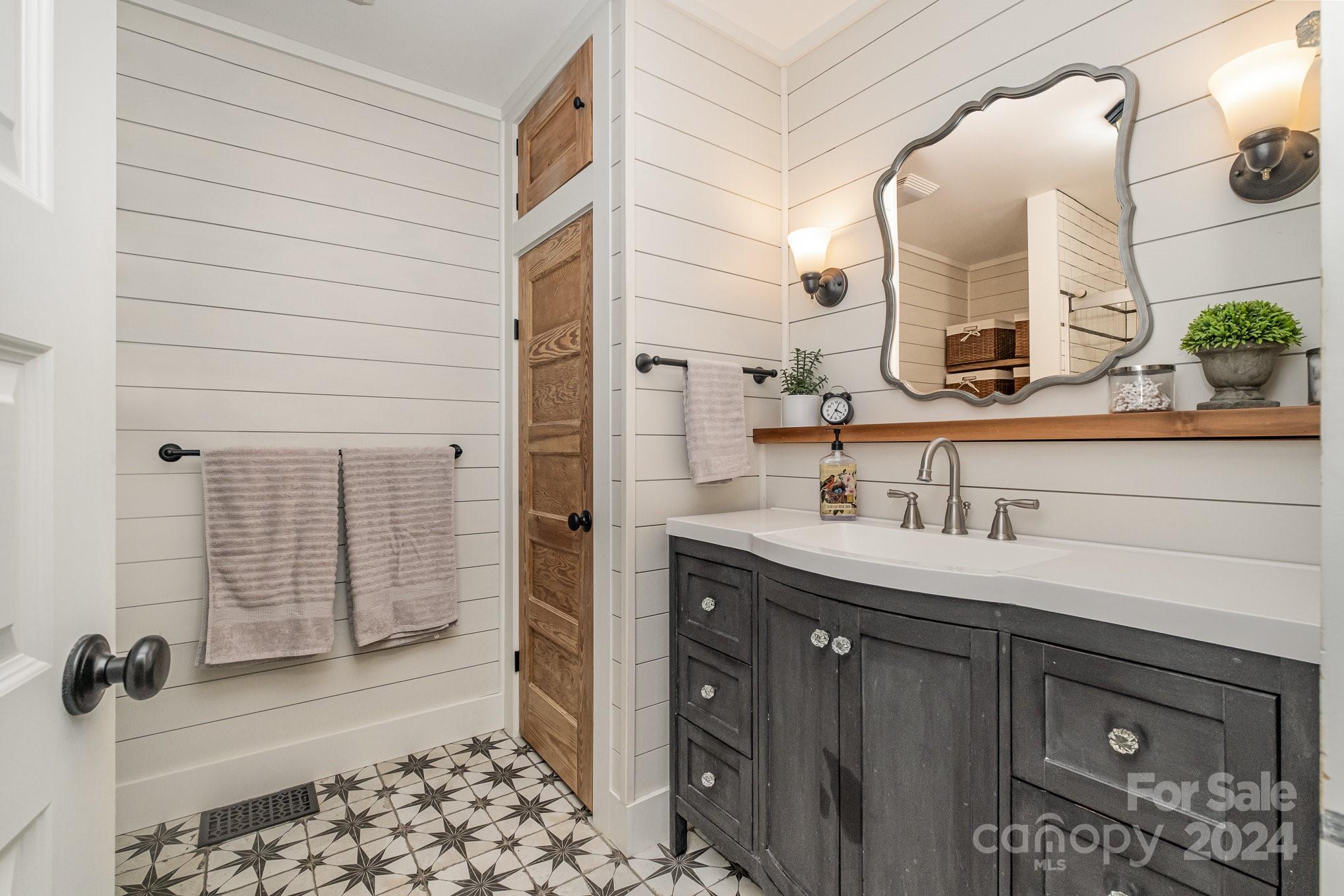 7707 Dellinger Road Denver, NC 28037 - Photo 30 of 46 a bathroom with a sink and a mirror