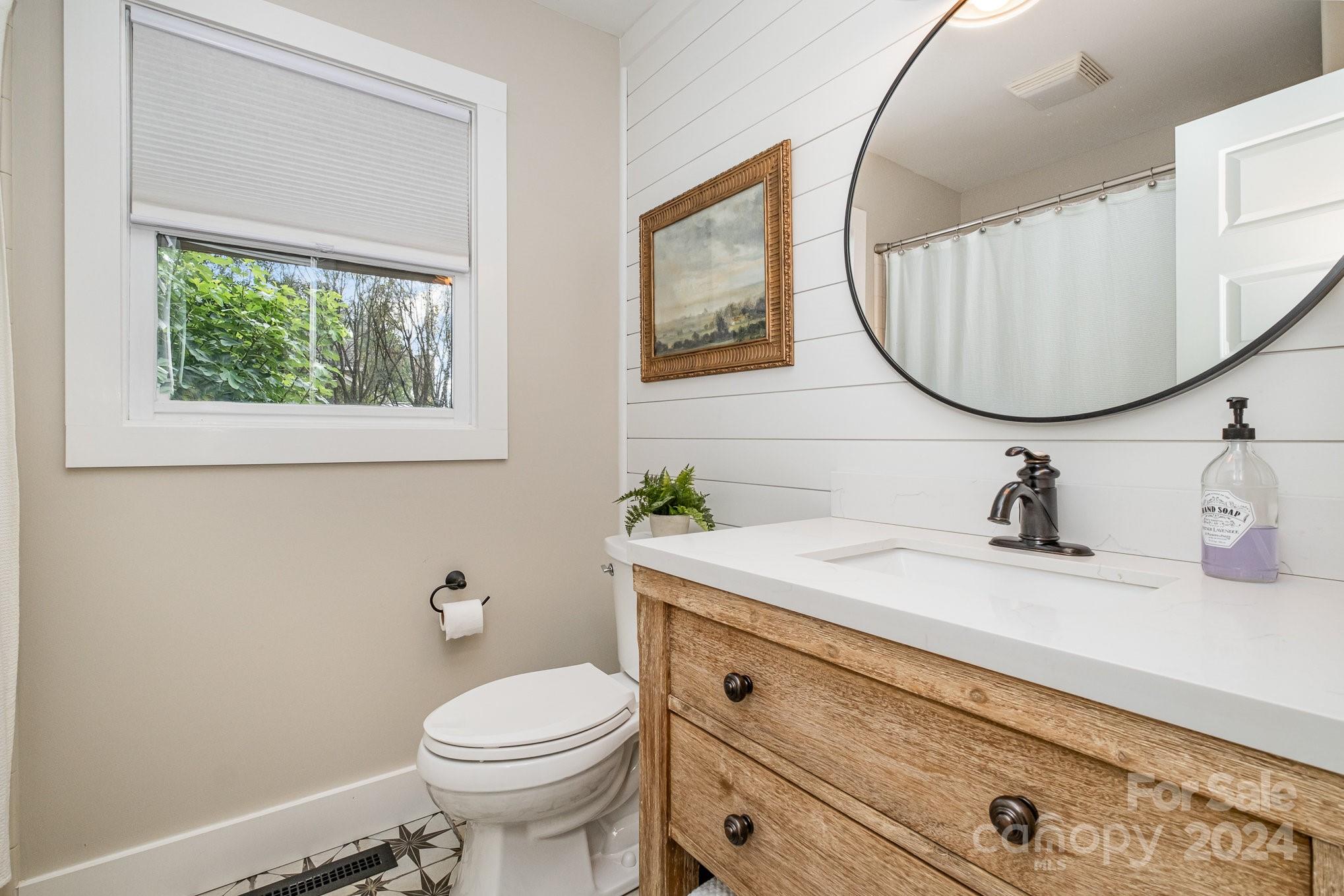 7707 Dellinger Road Denver, NC 28037 - Photo 32 of 46 a bathroom with a sink a toilet and a mirror