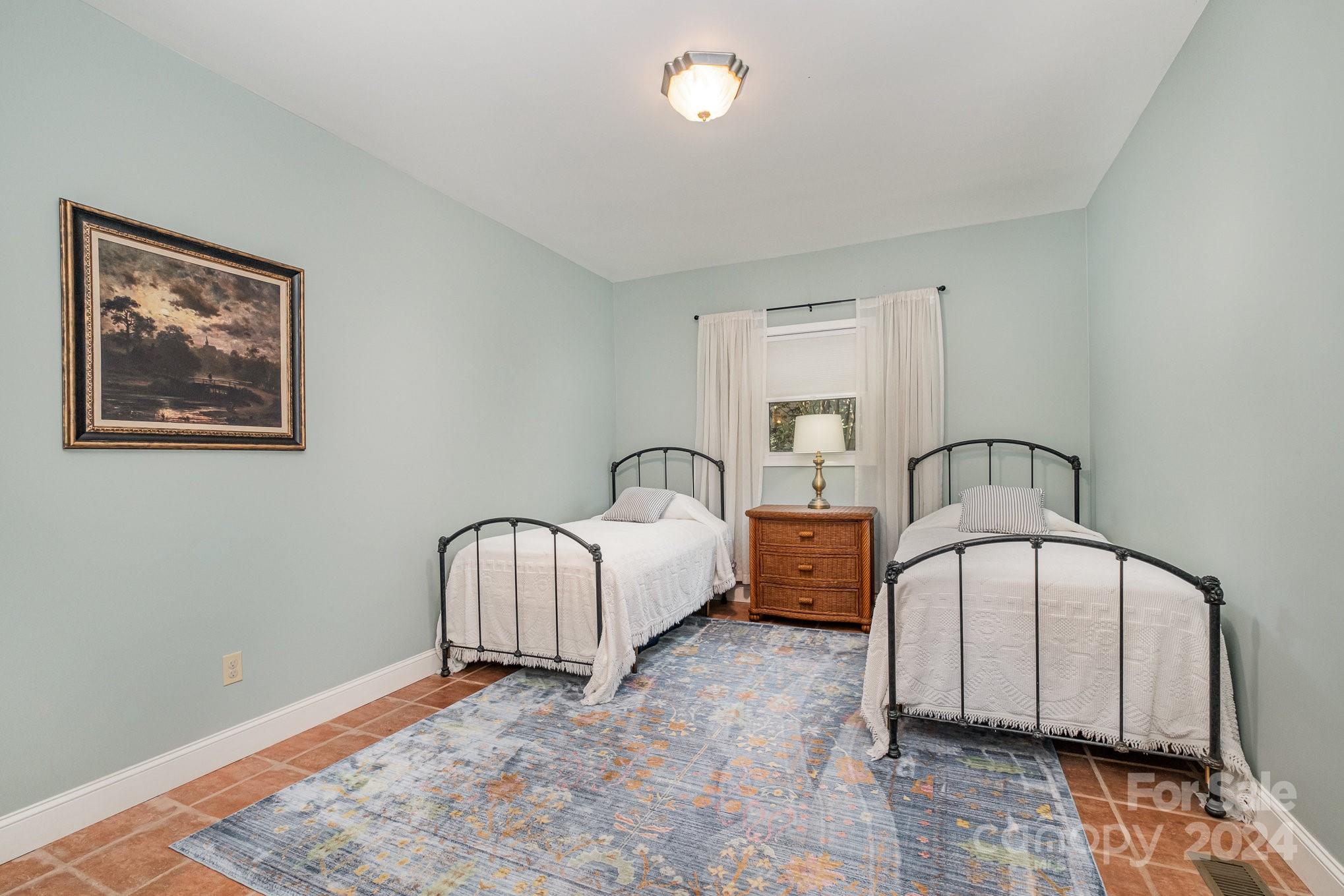 7707 Dellinger Road Denver, NC 28037 - Photo 35 of 46 a spacious bedroom with a bed and a window
