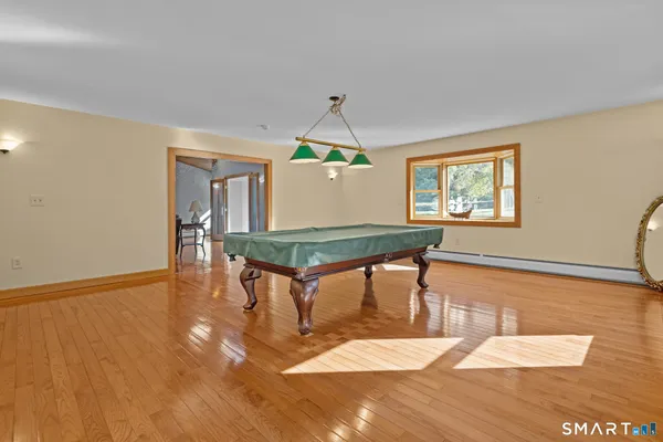 a living room with dining table and wooden floor
