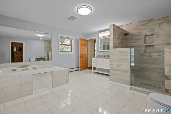 a bathroom with a sink vanity and mirror