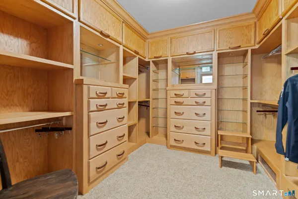 a view of walk in closet with clothes