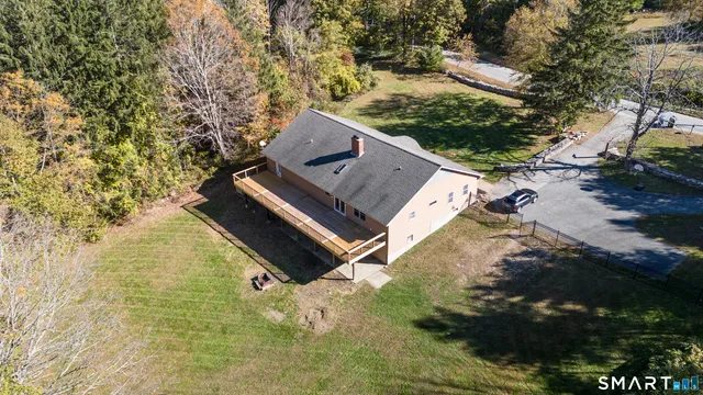 an aerial view of a house with yard swimming pool and outdoor seating