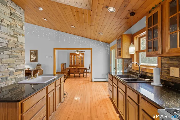a kitchen with sink a stove and cabinets