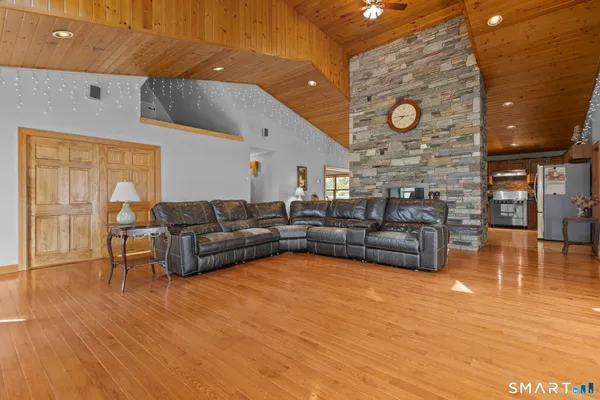 a living room with furniture and wooden floor