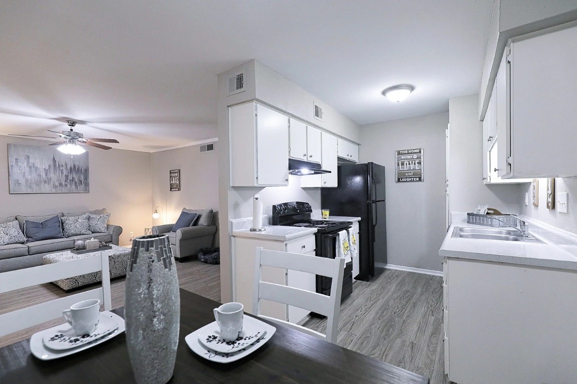 8100 North Mopac Expressway, Unit 5122 Austin, TX 78759 - Photo 27 of 28 a kitchen with stainless steel appliances kitchen island granite countertop a sink refrigerator and cabinets