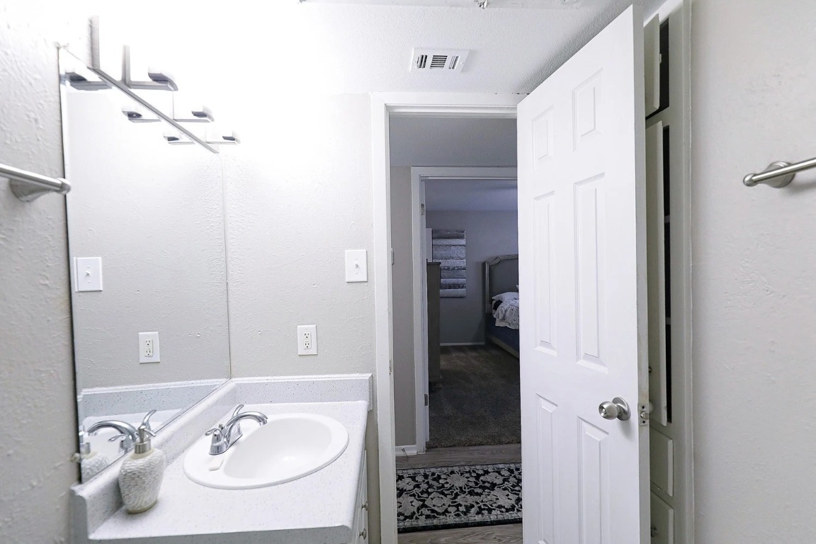 8100 North Mopac Expressway, Unit 5122 Austin, TX 78759 - Photo 20 of 28 a bathroom with a sink and a mirror