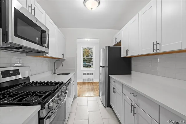 a kitchen with stainless steel appliances a refrigerator stove and microwave