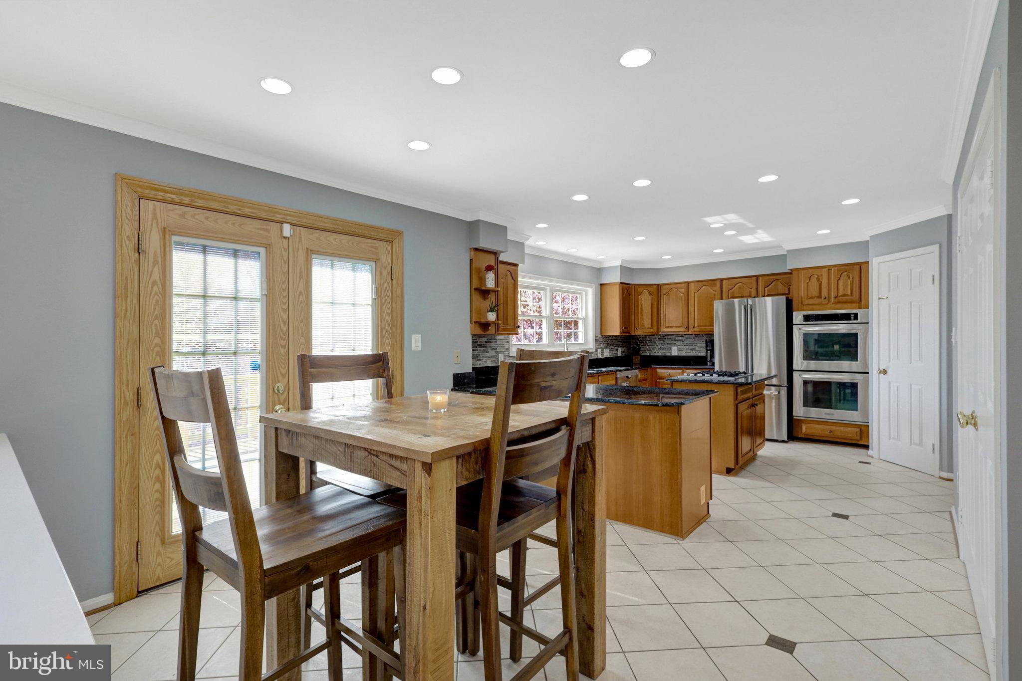 8497 Silverview Drive Lorton, VA 22079 - Photo 13 of 50 a view of a dining room with furniture and a kitchen