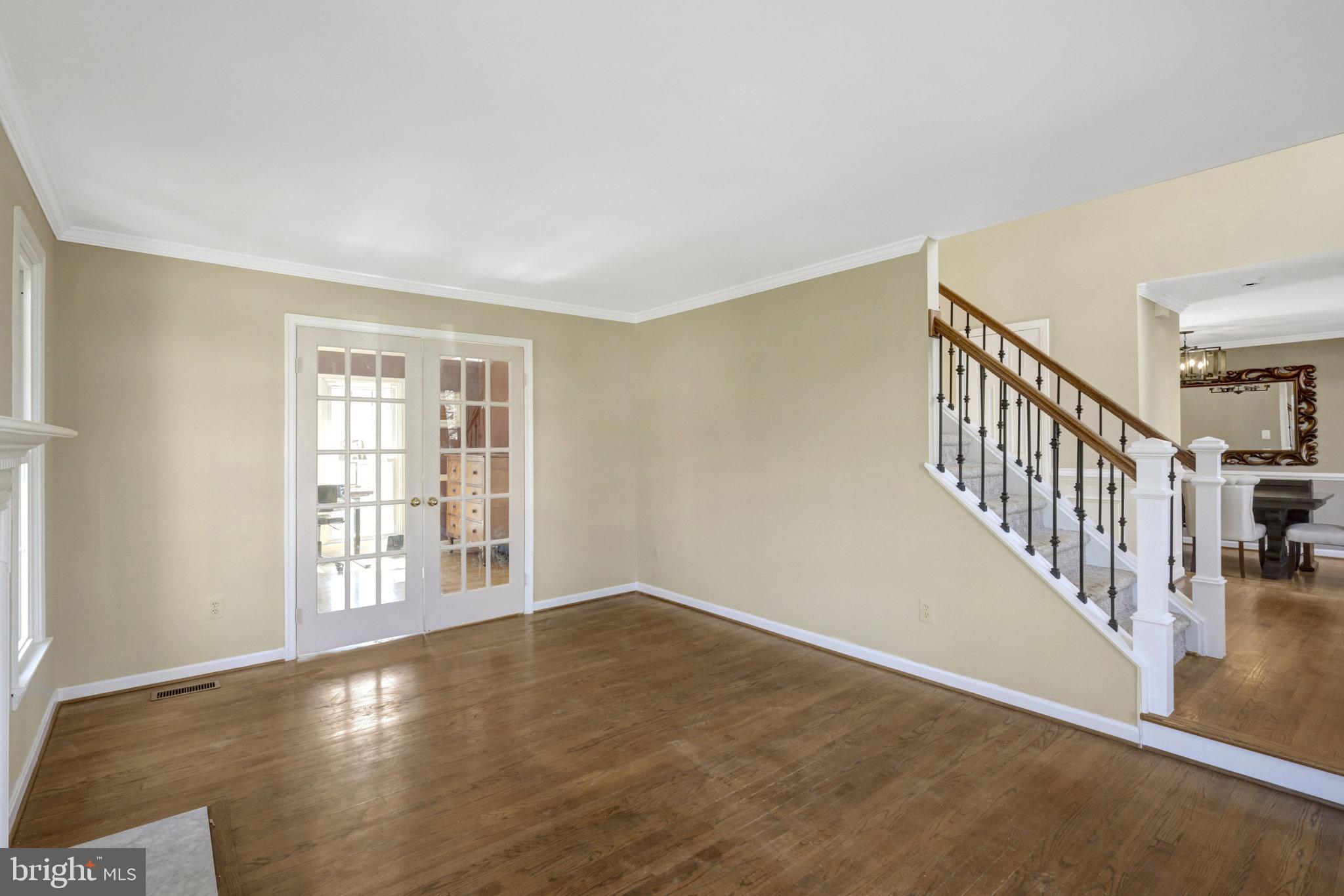 8497 Silverview Drive Lorton, VA 22079 - Photo 14 of 50 a view of an empty room with wooden floor and stairs