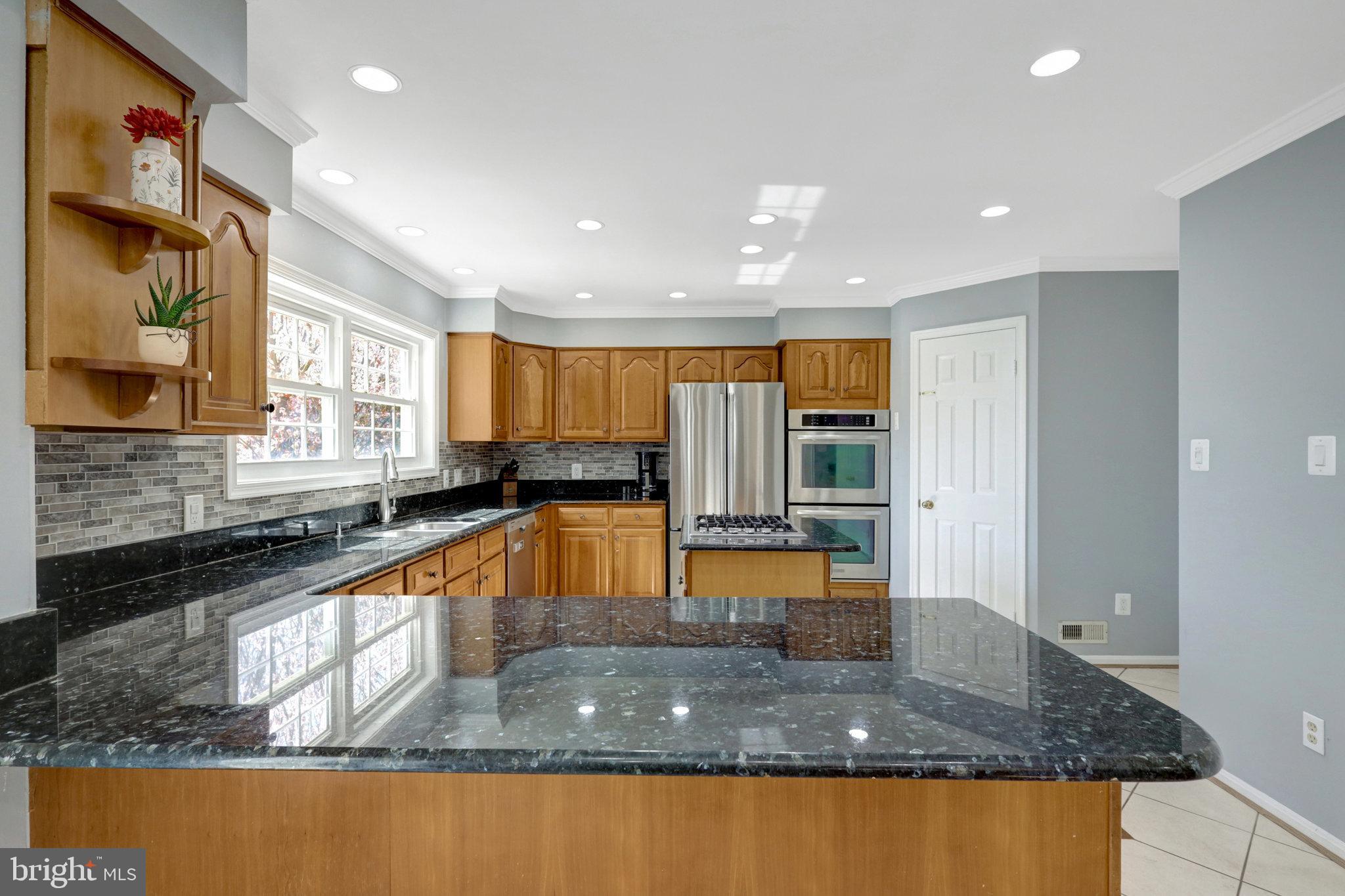 8497 Silverview Drive Lorton, VA 22079 - Photo 16 of 50 a large kitchen with kitchen island a large counter top stainless steel appliances and a counter top space