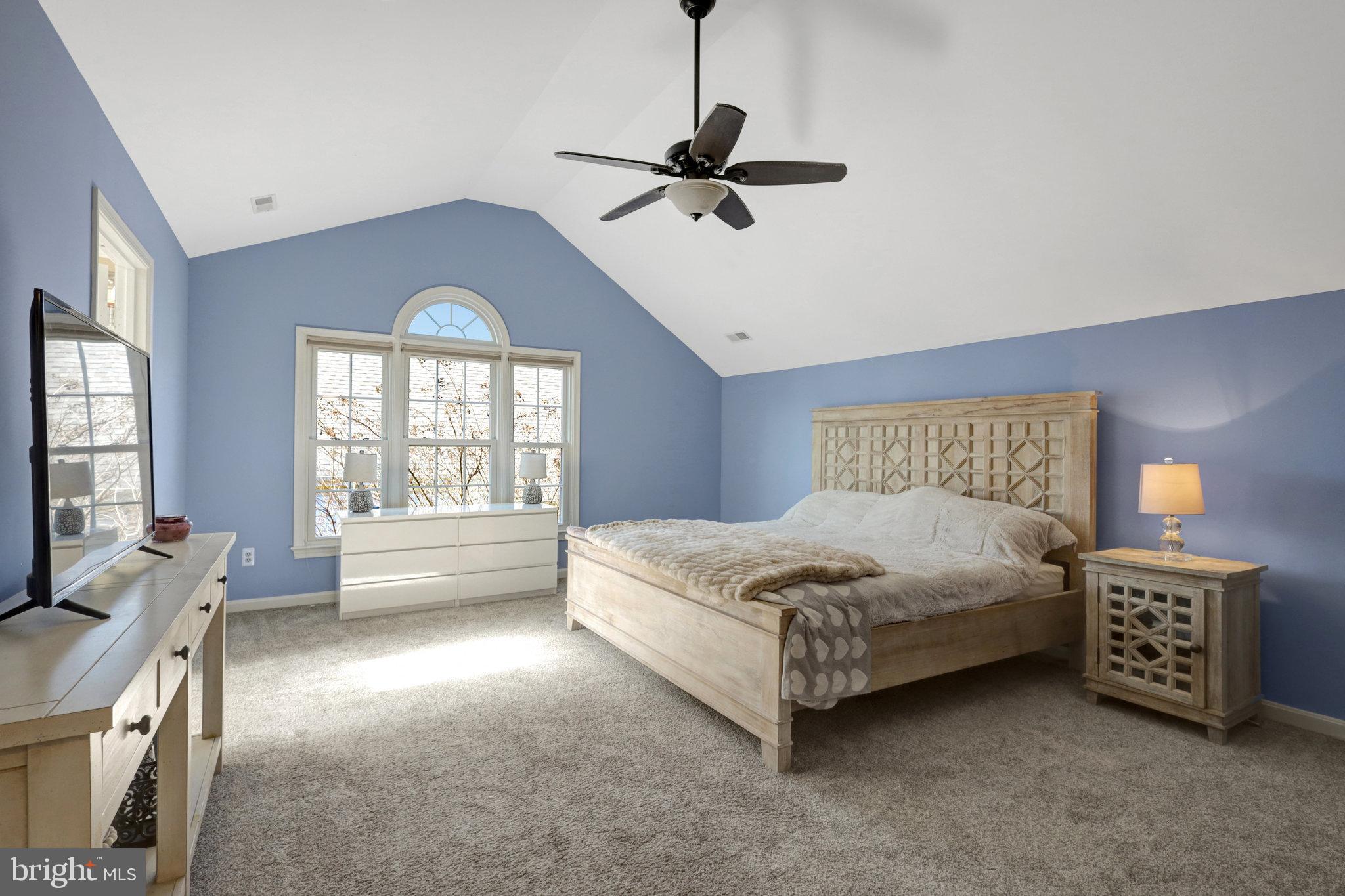 8497 Silverview Drive Lorton, VA 22079 - Photo 30 of 50 a spacious bedroom with a bed and a chandelier