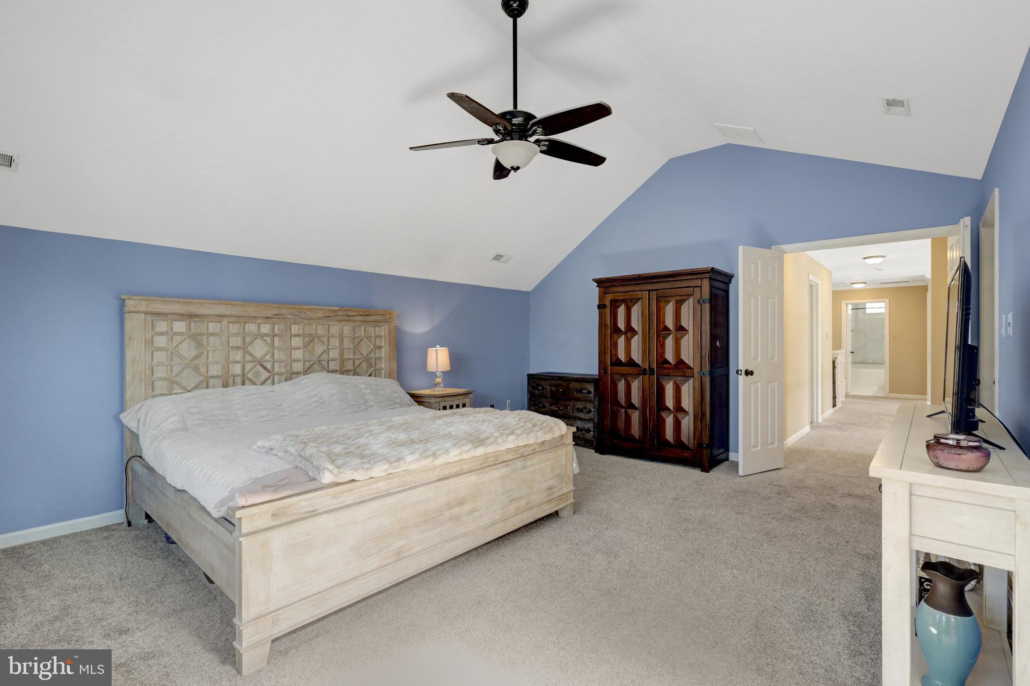 8497 Silverview Drive Lorton, VA 22079 - Photo 32 of 50 a bedroom with a large bed and a chandelier
