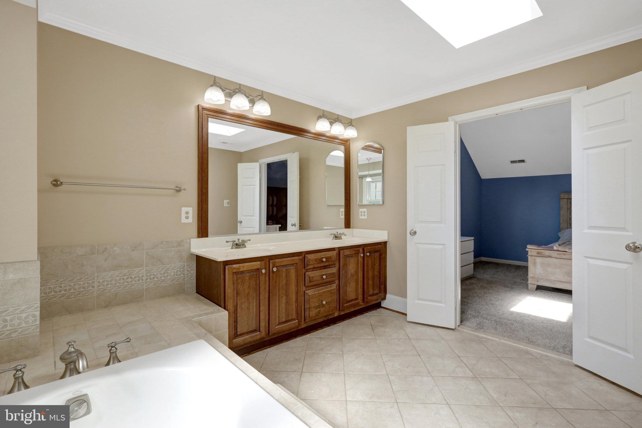 8497 Silverview Drive Lorton, VA 22079 - Photo 34 of 50 a spacious bathroom with a tub sink and mirror