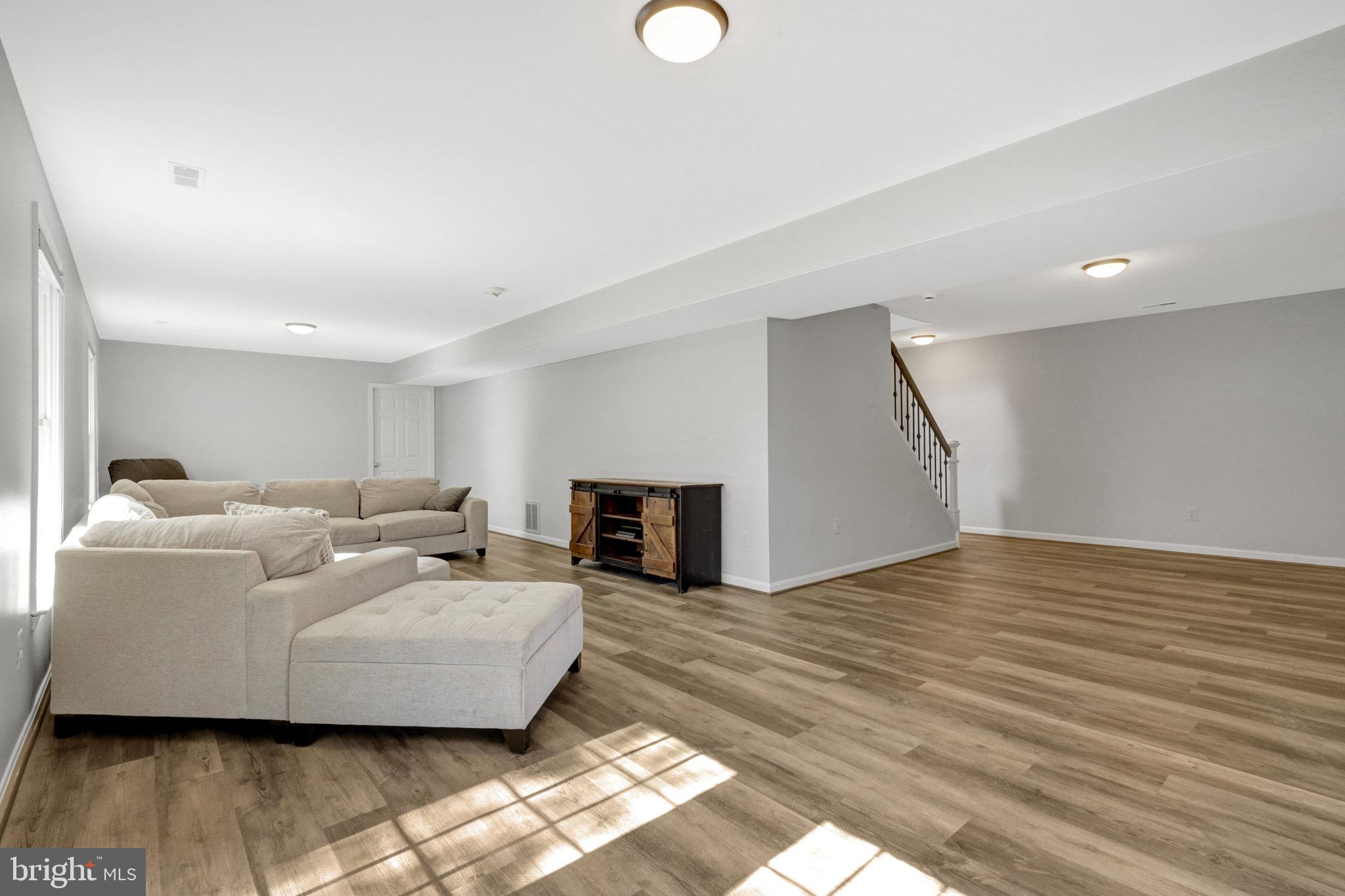8497 Silverview Drive Lorton, VA 22079 - Photo 37 of 50 a living room with furniture and a wooden floor