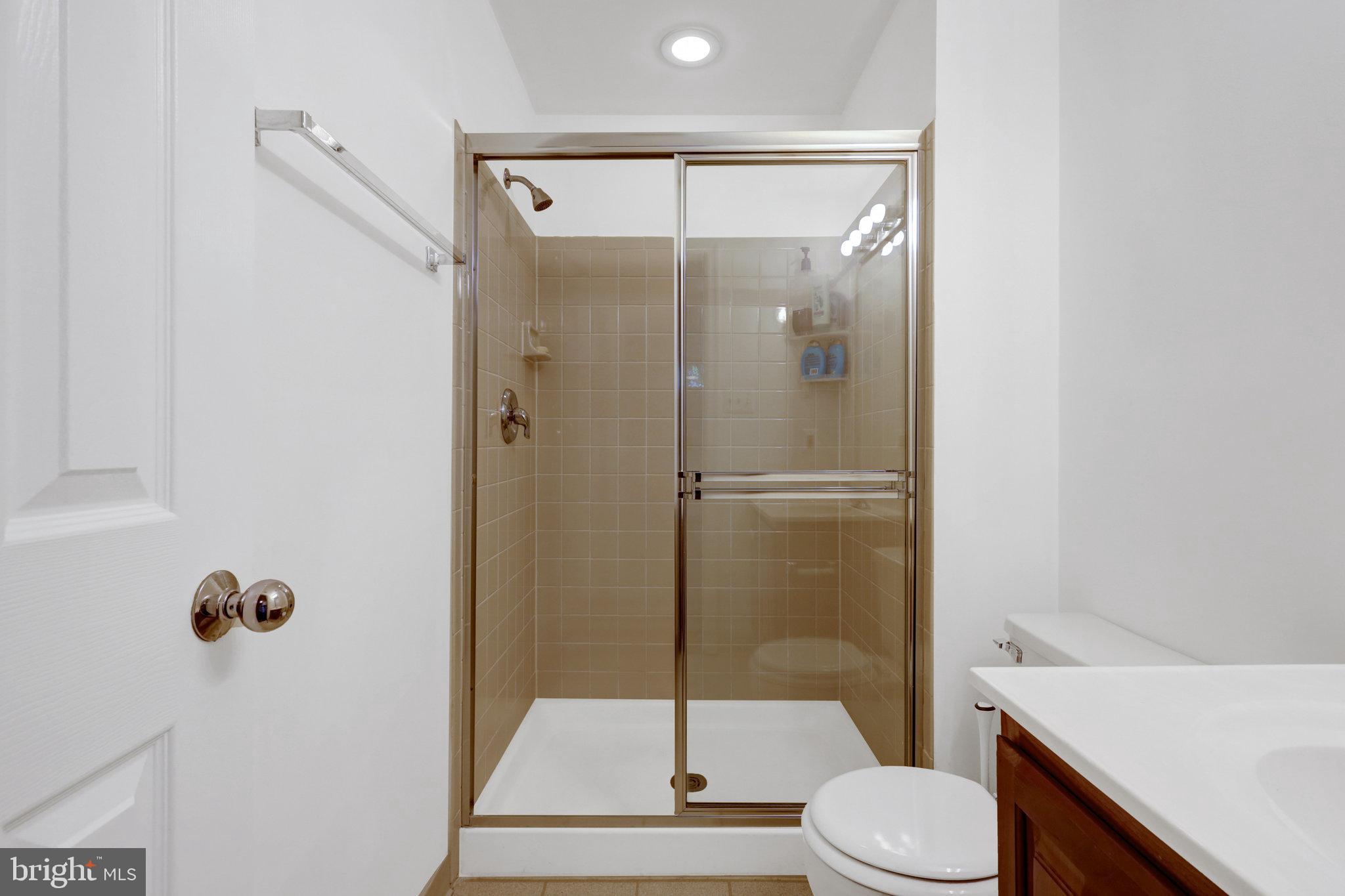 8497 Silverview Drive Lorton, VA 22079 - Photo 40 of 50 a bathroom with a shower toilet and sink