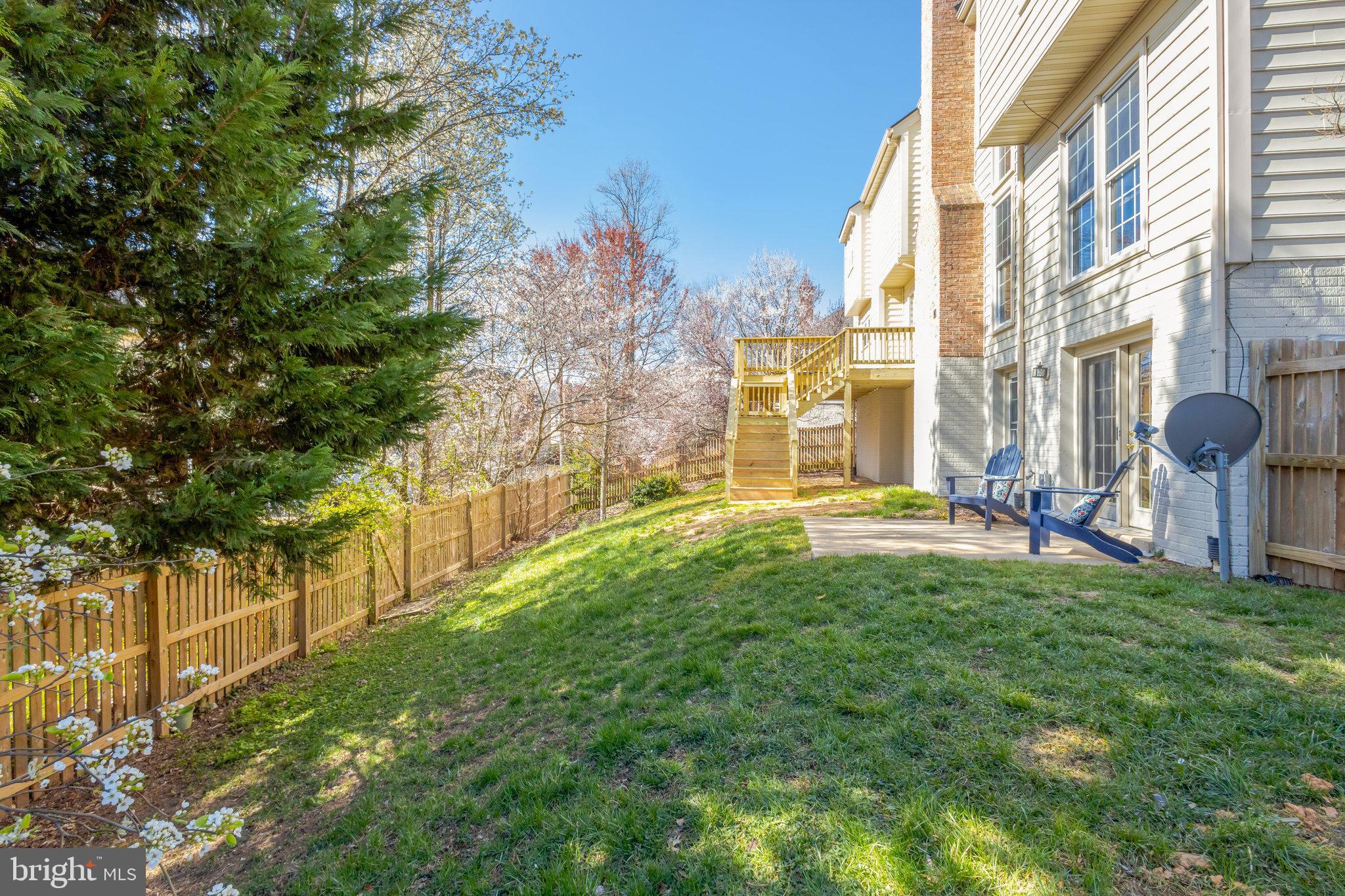 8497 Silverview Drive Lorton, VA 22079 - Photo 48 of 50 a backyard of a building with barbeque oven table and chairs