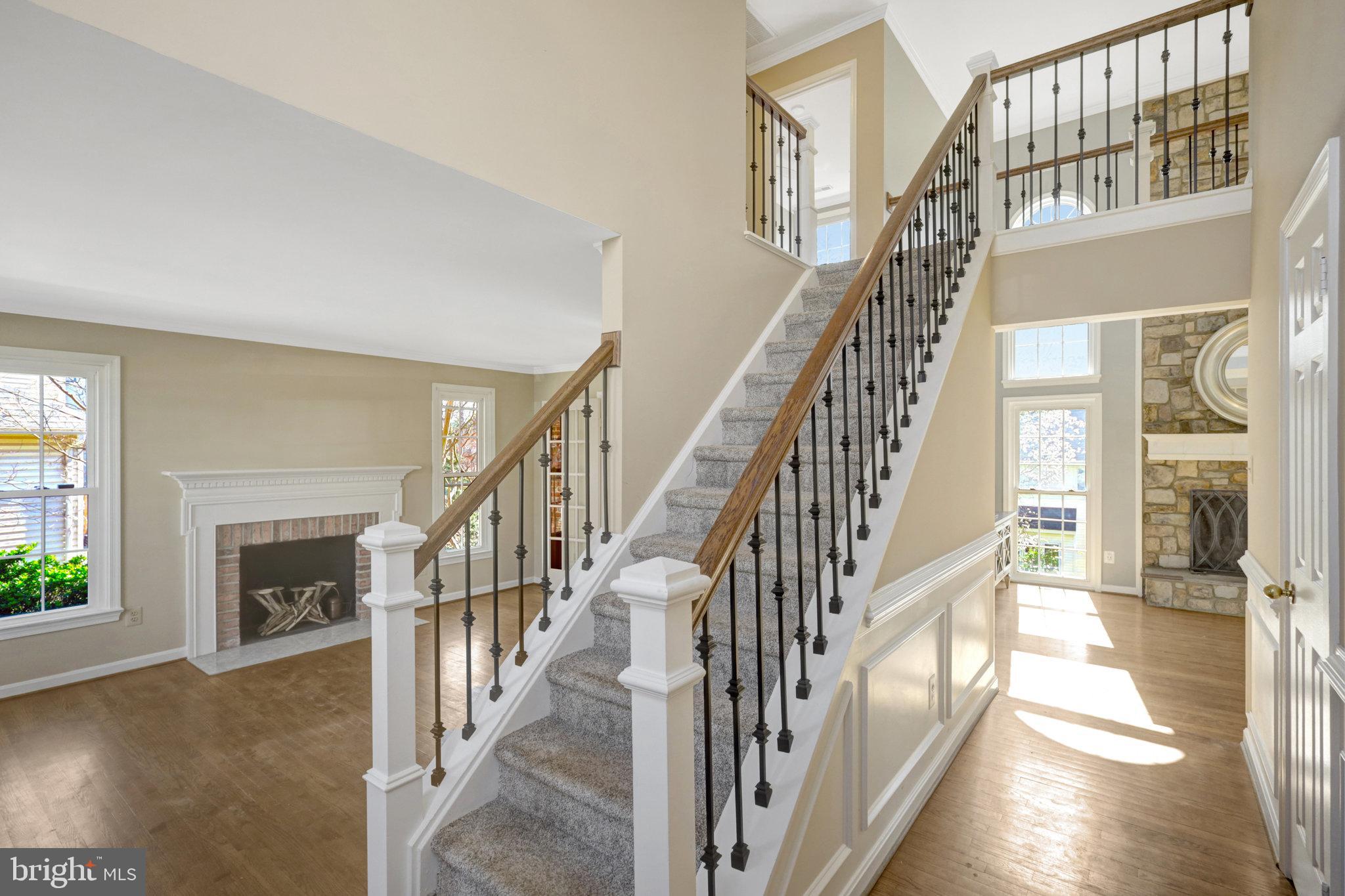 8497 Silverview Drive Lorton, VA 22079 - Photo 7 of 50 a view of staircase with lots of frames and wooden floor