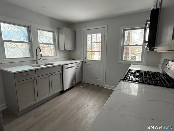 a kitchen with a sink stove and cabinets